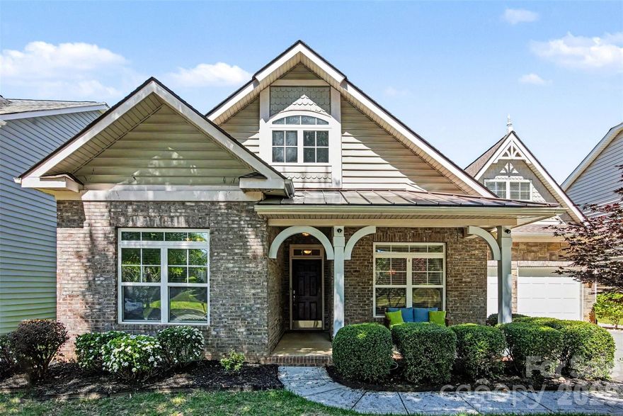 Thoughtfully designed 1.5-story home in the desirable Cureton community, offering a perfect blend of modern style and "peace of mind" updates. Step inside to a freshly painted interior that perfectly complements the rare hardwood flooring flowing throughout the entire main level and all bedrooms. The open-concept layout features a chef’s kitchen with granite countertops, white cabinetry, and stainless steel appliances, opening seamlessly to a family room with a cozy gas fireplace. The spacious main-level primary suite includes a versatile "bump-out" sitting area or home office, while two additional main-level bedrooms offer ultimate flexibility. Upstairs, discover an oversized bonus room/guest suite with a full bath. Outdoor living is a true highlight; enjoy the charming covered front porch or relax on the screened rear porch overlooking a private, mature lot enhanced by brand-new, professional landscaping. Premium maintenance updates include a new roof (2020), HVAC (2018), and a tankless water heater (2018). Enjoy resort-style amenities (pool, clubhouse, playground, trails) just minutes from downtown Waxhaw, Waverly, and Ballantyne in a top-rated school district. This turn-key gem is truly move-in ready!