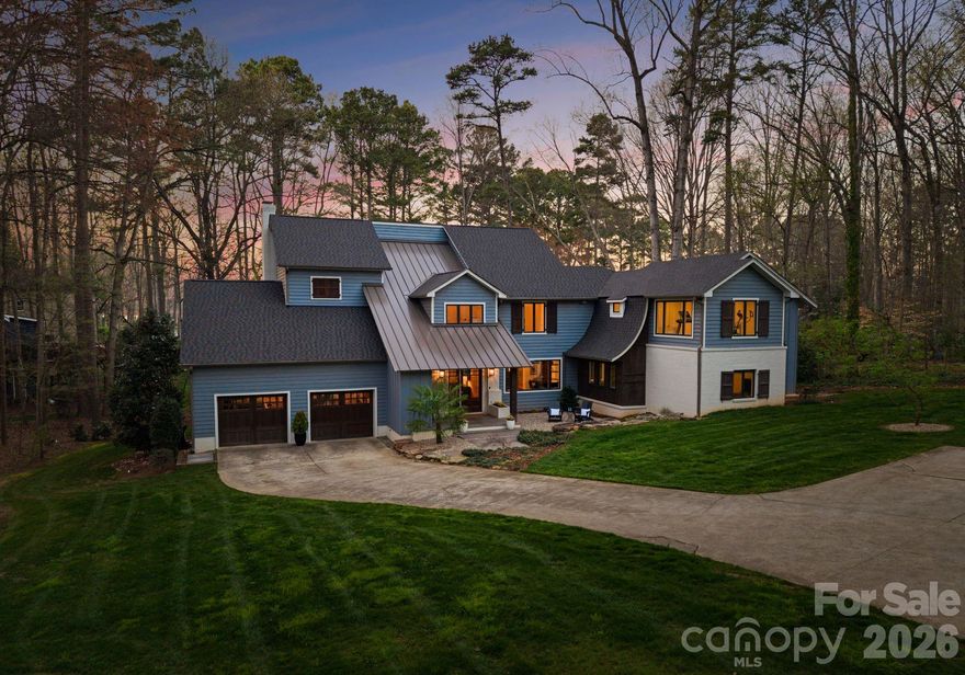 Quintessential Lake Norman lake house, completely reimagined and beautifully renovated through a thoughtfully designed 1,700-square-foot addition by architect Harry Schrader, offering long-range water views framed by towering mature trees and a peaceful, natural setting. Bordering approximately 3 acres of wooded common area, the home enjoys exceptional privacy and a natural backdrop rarely found.
Inside, the light-filled open floor plan showcases warm hardwood floors, a beautifully updated kitchen with abundant cabinetry and workspace, and inviting gathering spaces designed for effortless entertaining. Large windows and glass doors open to the screened porch, bluestone terrace, and Ipe wood deck, creating seamless indoor–outdoor living and the perfect setting for relaxed lake days and sunset evenings.
Every bedroom features its own private ensuite bath and walk-in closet, complemented by a bunk room, bar and entertainment space, workout area, and a dedicated art or creative room—thoughtfully designed for both everyday living and memorable lake weekends. The home also includes a spacious walk-in storage room with exterior access, ideal for conveniently storing kayaks, paddleboards, and lake gear.
This property is considered water view, with an easement providing easy access to the lake just steps away—offering all the advantages of lakefront living. A deeded boat slip with lift and jet ski lifts sits just steps behind the property within a private six-slip floating dock shared by only a small collection of neighboring homes—offering the ease and enjoyment of lake access that lives much like waterfront. Additional neighborhood amenities include a beach area, tennis and pickleball courts, basketball court, pool with pool house, and a private neighborhood launch site.
A rare opportunity to own a fully renovated Lake Norman retreat where privacy, nature, and timeless lake living come together beautifully.