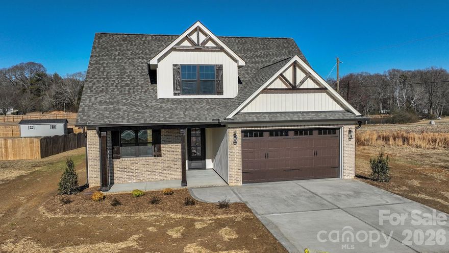 Stunning New Construction with Thoughtful Design & Premium Finishes

Welcome to this beautifully crafted new-construction home offering 3 bedrooms, 2.5 baths, and a spacious bonus room with a walk-in closet that can be used for many purposes. With 1,986 sq ft of living space, this open-concept layout features a dramatic two-story living room highlighted by an electric fireplace with a cedar mantle and floor-to-ceiling shiplap.

The main-level primary suite offers privacy and comfort, complete with a walk-in closet and a luxurious tiled walk-in shower. All bedrooms include walk-in closets, providing ample storage throughout the home.

Wood flooring flows through the main living areas, with cozy carpeting in bedrooms and tile flooring in all bathrooms. The kitchen is designed to impress with abundant staggered cabinetry, generous countertop space, a breakfast bar, and under-cabinet lighting—perfect for both everyday living and entertaining.

Additional features include crown moulding throughout, upgraded plumbing and light fixtures, an upstairs loft overlooking the living area, and a whole-home water filtration system. Enjoy outdoor living with a charming rocking-chair front porch, rear patio, and a large backyard ideal for relaxing or hosting guests.

This home offers a stunning layout, quality craftsmanship, and modern upgrades throughout—truly a must-see.