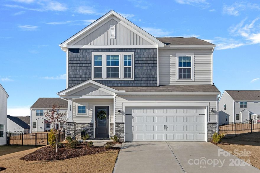 Located in the desirable Gambill Forest community, this stunning 2023-built home offers 4 bedrooms, 2.5 baths, and shows like a model. The charming exterior with a welcoming front porch sets the tone for this beautifully upgraded home. The main level boasts a spacious primary suite with walk-in closet and en-suite bath. The kitchen features granite countertops, impressive island, subway tile backsplash, 5-burner gas cooktop, and dark wood cabinetry. The kitchen flows seamlessly into the dining area and living room, making it perfect for entertaining. Upgraded vinyl plank flooring throughout the main level and stairs, along with updated ceiling fans and window treatments add modern elegance. Upstairs, you’ll find 3 more bedrooms and an expansive loft filled with natural light. The fully fenced, level backyard offers space for outdoor enjoyment, ready for you to personalize. With walk-in closets and ample storage, this home provides convenient living without compromising on space.