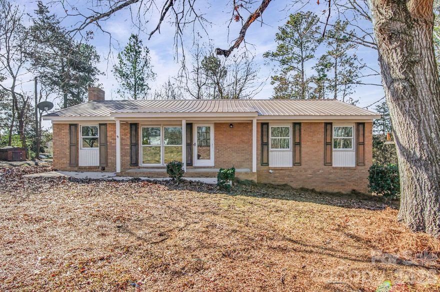 Charming, beautifully updated three bedroom/two bath brick ranch in northwestern Anson County. It has multiple upgrades including granite kitchen countertops, tile backspash in the kitchen, and tile showers in both bathrooms. Most of the home has original hardwoods, and the updated flooring is LVP. Natural light pours into the living room through huge picture windows. A secondary den/family room has a brick fireplace with functional gas logs for a cozy place to relax. The outbuilding and deep crawlspace provide ample storage. Located on one acre in the country, you have plenty of space for outdoor living while being easily accessible to Anson, Stanly and Union Counties. Take a look today!