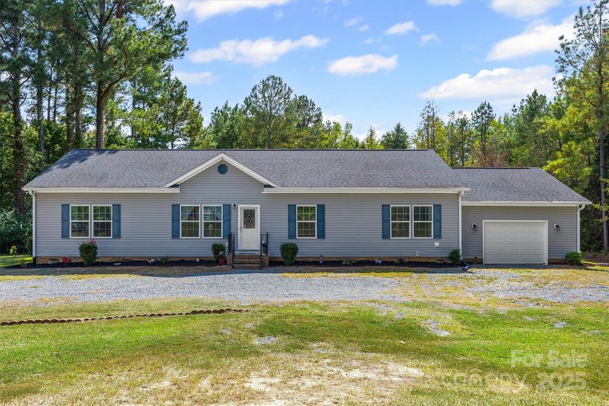 Beautiful 3BR/2BA home across from Cane Creek Park complete w/ garage, screened patio AND deck! Very private 2.34 acre lot and NO HOA!  The spacious open floorplan and split bedroom plan are thoughtfully designed. Crown mouldings throughout. The family room AND additional flex space provide plenty of room for everyone to spread out! LVP floors are great looking and low maintenance. Family room with built-ins is a central spot to gather. Kitchen has a large island, stainless steel appliances, double ovens, tile backsplash and pull out shelves in the cabinets. The laundry room is a show stopper with tons of space and cabinets for organization. Adjacent to the laundry room is a drop zone and utility sink that provides both function and convenience. Primary bedroom and ensuite bathroom are HUGE and so well appointed! Two secondary bedrooms are spacious and have lots of natural light. The versatile flex space is another area for gathering, working from home or just relaxing- you choose! The backyard is fully fenced and there is an additional enclosed/fenced area for animals to call their own. The garage is oversized and had plenty of room for storage, tools, lawn/garden items- you name it! Home comes equipped with a water filtration system and a water softener. This lovely home is right across from Cane Creek Park which has 1,300 acres of woodlands and a 300 acre lake. Activities like kayaking, paddle boarding, fishing, archery, an amphitheater and campgrounds make this the ultimate location for nature lovers!  Short drive to shopping and dining in Historic Downtown Waxhaw too!  Come fall in love with country living!
