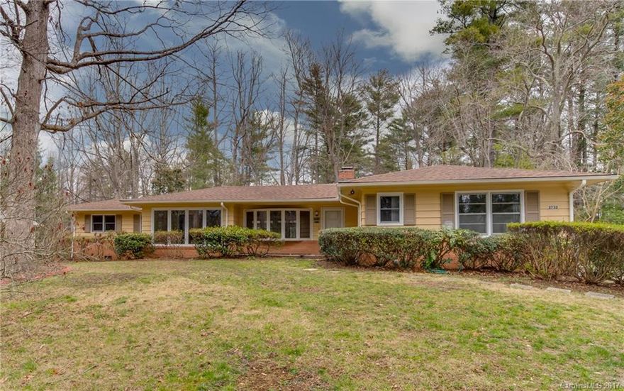 Charming 2BR/1.5 rancher in quiet neighborhood convenient to city.  Newer roof,  open floor plan w/large windows in living/dining,  hardwood floors, tile bathrooms, breakfast area,  Gorgeous large fireplace converted to gas, will need logs replaced.  Interior freshly painted.  Home is mostly vintage including appliances, but has been freshly painted and has some kitchen cabinet updates, but awaits a loving touch by a new owner.  Large lot with wooded privacy outback on .51 acres MOL.