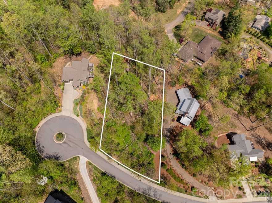 Rare opportunity to build in Beaucatcher Heights, one of the city’s most sought-after in-town communities. Located in the historic Kenilworth neighborhood, this 0.69-acre wooded homesite offers a private, gently sloping setting ideal for a custom luxury residence. Just minutes to downtown Asheville, Biltmore Village, and Mission Hospital, the property combines natural mountain surroundings with exceptional everyday convenience. The lot is well-suited for modern mountain architecture, and existing plans by award-winning Rusafova Markulis Architects are available, providing a valuable head start for buyers or builders. Beaucatcher Heights is known for its walkable streets, sidewalks, and established infrastructure, along with thoughtfully designed homes that blend into the surrounding forest. Opportunities for build-ready land this close to downtown Asheville are increasingly limited, making this an ideal investment for a primary residence, second home, or spec build in a proven luxury neighborhood.