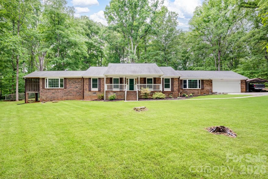 Welcome to peaceful country living on 3.15 beautiful acres, tucked away in a quiet, established neighborhood. This spacious ranch-style home offers four bedrooms, including two ensuites, perfect for family, guests, or multi-generational living. One of the primary suites feature dual closets, bath with shower, and its own screened porch where you can enjoy your morning coffee while listening to the sounds of nature. The heart of the home is a roomy, inviting kitchen with plenty of cabinetry, generous counter space, Silestone countertops, a tile backsplash, and a center island with bar seating, ideal for gathering after a long day. A cozy dining area completes the space, making it perfect for everyday meals or weekend get-togethers. The large living room welcomes you in with a wood-burning fireplace, brick mantle, and built-in wood storage, creating a warm, rustic feel. Just off the living room, a dedicated office offers a quiet space to work or relax. Step outside and take in the wide-open space, enjoy evenings on the deck overlooking a fenced backyard shaded by mature trees, with plenty of room to roam, garden, or even add a future pool. Two car attached garage.  Along with a two car detached garage, extra parking pad, and a powered shed, there’s no shortage of space for equipment, hobbies, or a workshop. Heating and cooling with heat pump for 2 zones provide more efficiency. AT&T or Comporium internet available.  Easy access to Hwy 77. If you’ve been dreaming of a little more space, fresh air, and room to spread out, this property delivers the charm and comfort of true country living.