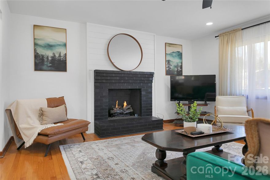 This impeccably maintained and newly renovated one-level, low maintenance, brick ranch on over a HALF ACRE lot in the Heart of Brevard is calling your name! Host with ease in the brand new kitchen featuring wraparound quartz countertops with an eat-in bar area, porcelain tile in the kitchen and brand new stainless steel appliances! The bright and airy living room impresses immediately, showcasing a gas fireplace with brick and shiplap surround, recessed lighting, beautifully restored original hardwood flooring & fresh paint throughout. A special nod to style and design with the bathrooms, meant to thoughtfully preserve, celebrate and reflect the home's original era. Enjoy the refreshing mountain air on the large 13x9 deck with built-in seating overlooking a spacious, level backyard with endless possibilities perfect for entertaining, hosting backyard summer BBQs, relaxing or even future expansion space! The 16x12 storage building provides convenient additional storage or even a workshop/hobby space. New roof and gutters installed in 2021 on home & a new roof on the storage building. Fully encapsulated crawlspace with dehumidifier. This prime location is just steps away from the Brevard Greenway and Ecusta Trail and directly across from Straus Park and Food Matters Market & Café. Only minutes to downtown Brevard and Brevard College, and just one mile to Transylvania Regional Hospital and multiple medical offices. Surrounded by nature and outdoor recreation with quick access to Pisgah National Forest, DuPont State Park, Gorges State Park, and Headwaters State Forest. This home and location is perfect for those who value quality, convenience and an active, outdoor lifestyle! Whether you are downsizing, just starting out or searching for the PERFECT mountain get-away, look no more!