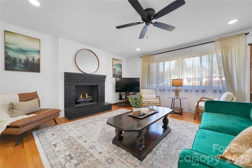 This impeccably maintained and NEWLY renovated one-level, low maintenance, 3 BR/1.5 BA full brick ranch on over a HALF ACRE lot and NO HOA in the Heart of Brevard is calling your name! Host with ease in the brand new kitchen featuring wraparound quartz countertops with an eat-in bar area, porcelain tile in the kitchen and brand new stainless steel appliances! The bright and airy living room impresses immediately, showcasing a gas fireplace with brick and shiplap surround, recessed lighting, beautifully restored original hardwood flooring & fresh paint throughout. A special nod to style and design with the bathrooms, meant to thoughtfully preserve, celebrate and reflect the home's original era. Enjoy the refreshing mountain air on the carport or large 13x9 deck with built-in seating overlooking a spacious, level backyard with endless possibilities perfect for entertaining, hosting backyard summer BBQs, relaxing or even future expansion space! The 16x12 storage building provides convenient additional storage or even a workshop/hobby space. New roof and gutters installed in 2021 on home & a new roof on the storage building. Fully encapsulated crawlspace with dehumidifier. This prime location is just steps away from the Brevard Greenway and Ecusta Trail and directly across from Straus Park and Food Matters Market & Café. Only minutes to downtown Brevard and Brevard College, and just one mile to Transylvania Regional Hospital and multiple medical offices. Surrounded by nature and outdoor recreation with quick access to Pisgah National Forest, DuPont State Park, Gorges State Park, and Headwaters State Forest. This home and location is perfect for those who value quality, convenience and an active, outdoor lifestyle! Whether you are downsizing, just starting out or searching for the PERFECT mountain get-away, look no more!