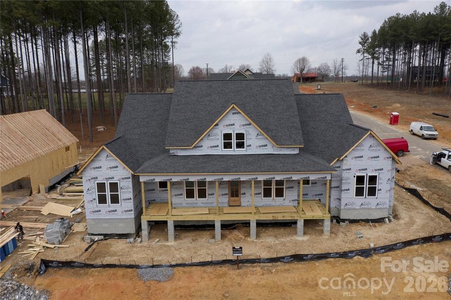 Luxury Custom Farmhouse Spec in Mills Garden at Woodstone. This beautiful new construction is set on a 0.29-acre lot and is set to be completed on 5/15/2026.  Woodstone Communities “Ironwood” is a single-story ranch, approximately 2,802 sq ft with 4 bedrooms plus an office, 3.5 baths designed with upscale finishes and a thoughtful layout. The open chef’s kitchen is built for entertaining. It features custom cabinetry, upgraded quartz countertops throughout, gourmet Z-Line gas range and appliances. This opens to your living room area that features a gas fireplace, vaulted ceilings and a huge sliding panel patio door that opens to your large, covered porch with Trex decking allowing for indoor/outdoor entertainment. The primary suite offers a huge bedroom with vaulted ceilings, spacious walk-in closet with custom built-ins and dresser drawers, and a spa-inspired bath with soaking tub and custom tilework. Additional highlights include huge plank LVP flooring, tile and carpet flooring, custom wood shelving throughout. Exterior features Hardie siding with beautiful foundation brick veneer for lasting curb appeal. Includes a huge 3-car garage, sealed crawlspace foundation equipped with a dehumidifier.