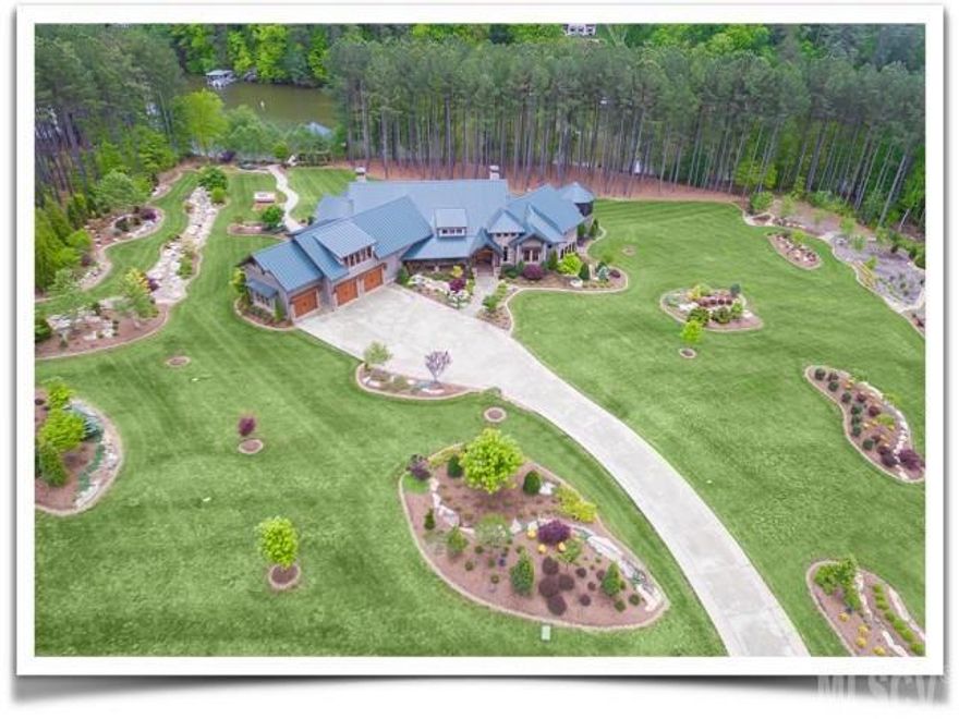 Exquisite Lake Hickory home with over 8,000sqft,  & 500ft of shoreline on more than 4 impeccably landscaped acres.  The main level features a living room, dining room with fireplace, large great room open to the gracious kitchen. The master suite accesses the deck & has an expansive bathroom. The first floor also includes a guest suite, office & butlers pantry.   The lower level includes a gathering room with fireplace, billiard room, bedroom, large bathroom, gym, indoor lap pool, & elevator. The upper level has a craft/bonus room that could also be another guest suite with a private bathroom. The outdoor living area offers many amenities including a kitchen & dining area, screened porch, fresh water pond, stone fire-pit, green house, & stamped path to the boat house. This home is energy star qualified/green certified & is designed with numerous accessibility features. No detail has been overlooked in this amazing retreat with stunning indoor & outdoor entertainment areas.