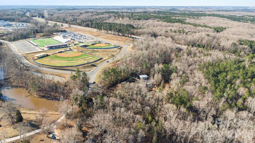 This beautiful 3.11-acre property in Lancaster offers a rare opportunity to build your dream home in a peaceful and natural setting while still being conveniently located near modern amenities. Surrounded by mature trees and natural landscape, the land provides a private, scenic environment with plenty of space to create a custom home, outdoor living areas, or additional improvements.

The property features a gently wooded setting with a paved road frontage and expansive views of the surrounding countryside. With over three acres, there is ample room to design a home site that takes advantage of the privacy and natural beauty of the land. The lot offers flexibility for residential use and provides the ideal canvas for creating a quiet retreat away from the bustle of the city.

Located in Lancaster County, the property offers a relaxed rural atmosphere while remaining within easy driving distance of nearby shopping, dining, and everyday conveniences. The area continues to grow while maintaining its scenic charm, and nearby towns such as Indian Land, Fort Mill, and the greater Charlotte area provide additional options for work, recreation, and entertainment.

This property presents a wonderful opportunity for anyone looking to build a custom home on acreage while enjoying the beauty and tranquility of the surrounding landscape.