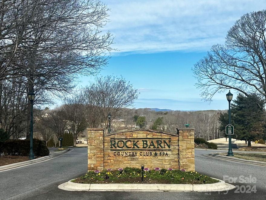 Prestigious ROCK BARN living! All brick, main level living ON THE GOLF COURSE!  Lovely one acre, level lot situated on hole number 17 of the renowned Tom Jackson course.  Rock Barn has amazing opportunities for golf, club membership, tennis, swimming, and a world class SPA, all in your backyard. (Fees/membership required for club amenities) This one owner, custom built home has endless possibilities!  Wonderful floor plan has split bedrooms including spacious primary en suite with walk in closet. Other two bedrooms also offer their own private baths. Large family/den area with gas fireplace flanked by French doors leading to brick patio that overlooks golf course.  Kitchen has stainless appliances, stone countertops, two pantries.  Oversized two car garage with stairs leading to walk up attic perfect for storage!