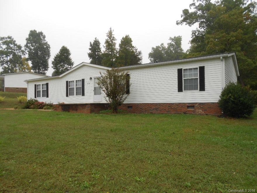 Well maintained 2001 Doublewide Home in Troy Acres, a community of similar homes in the desirable North Lincoln School district.  Lots of square footage in this great home, with a Living Room, Den, huge Kitchen & Breakfast area, 3 Bedrooms, 2 Baths on a .54 acre lot.  Plenty of space to move around with nearly 1700sf of heated living area.  Awesome Master Suite.  Newer laminate wood floors, carpet, roof & water heater.  Includes refrigerator & storage bldg.  Great yard for outside activities!