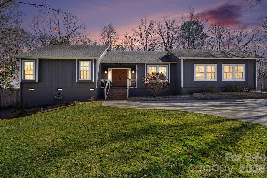 Welcome home to this beautifully updated 3-bedroom, 2-bathroom ranch in the desirable Woodberry Forest neighborhood of Charlotte. Thoughtfully improved during the sellers’ ownership, this home offers comfortable one-level living with both indoor and outdoor spaces designed to enjoy year-round. A covered front porch creates a warm first impression and inviting entry. Inside, the large remodeled kitchen serves as the heart of the home, offering an easy flow for everyday living and entertaining. The dining area is accented by a dry bar, providing additional cabinetry storage and a functional space for serving and entertaining. The cozy living room features a beautiful stone gas log fireplace and a vaulted ceiling with wood beams, adding warmth and character to the main living space. Just off the kitchen, a huge bonus room provides flexible space for a second living area, playroom, home office, or media room. Tucked away down the hall, are the bedrooms and bathrooms. The hall bathroom has been upgraded with a new vanity and a recently reglazed bathtub, while the spacious primary suite features a walk-in closet and private ensuite bath. Major system updates in recent years include a replaced HVAC and water heater, providing added peace of mind for the new owner. The exterior was painted for a modern twist, and most of the windows and interior doors have been replaced for a refreshed, cohesive feel throughout. Outdoor living truly shines here. The large, fully fenced backyard is enhanced by mature trees, and upgraded landscaping and hardscaping in both the front and back. Enjoy time on the refurbished back deck or gather around the newly installed concrete patio and firepit area. A French drain was added in the backyard for improved drainage, and the driveway was repaved to create a flatter parking space at the top for added convenience. This move-in ready ranch blends thoughtful updates, functional living space, and inviting outdoor areas—all in an established Charlotte neighborhood located close to Uptown, Matthews, Southpark and Cotswold. Don't miss out on this beautifully maintained, well-thought out home!