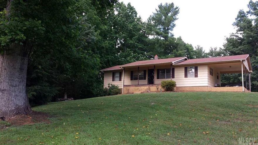 Country setting on 1.74 acres. Ranch style with split bedroom floor plan. Eat-In kitchen. Full unfinished basement with room for expansion with single car garage. Laundry in basement. Plenty of storage. Rear back deck and covered front porch. Single carport attached. Outbuilding stays. Roof replaced 1989. HVAC new in 2010. Home is on well and septic tank. Paved drive goes around back of house with access to basement garage.