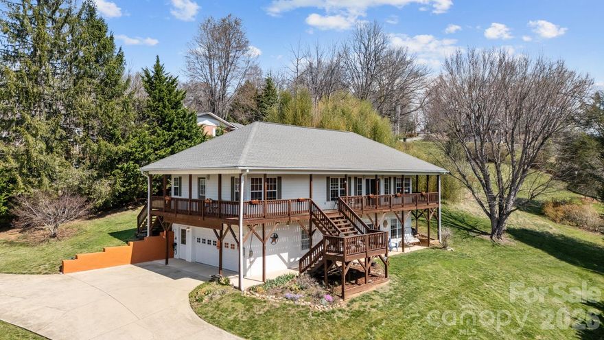 MAJOR PRICE IMPROVEMENT- Beautiful turn-key home with motivated sellers—priced to sell and won’t last long! Seize a rare opportunity to own a charming mountain-view home just blocks from downtown Waynesville. Perfect as a primary residence, investment property, or multi-generational setup. This home offers flexibility, comfort, and an unbeatable walkable location near local shops, restaurants, and community amenities. Step outside to the stunning wrap-around balcony showcasing breathtaking 360° mountain views — the perfect place for morning coffee or evening sunsets. The main level welcomes you to a spacious kitchen, cozy sunroom, and a large formal living room featuring a fireplace that creates a warm, inviting atmosphere. Two comfortable bedrooms and two full bathrooms provide easy everyday living, while the attached garage adds convenience. INCOME OPPORTUNITY - The lower level includes a private entrance and its own kitchenette, living area with an electric fireplace, bedroom, full bath and a half bath — ideal for extended family, guests, or generating rental income. Just a 12 minute walk to downtown Waynesville. 6 minute walk to the Dog, skateboard and baseball park. 8 minute walk to the Waynesville Rec center and Richland creek. Also on the rec center property there is a track and a walking path near the creek. A must-see property that blends mountain charm, location, and income potential.