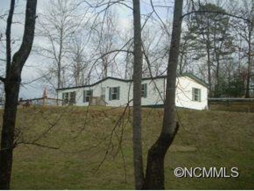 Dillsboro - Good view, easy access, nice manufactured home on 0.65+/- acre lot.  Home features split plan with 3BRs/ 2BAs, central heat and air.  Recently painted, new laminate floors, gas fireplace, nice Deck and large storage building/workshop with electricity.