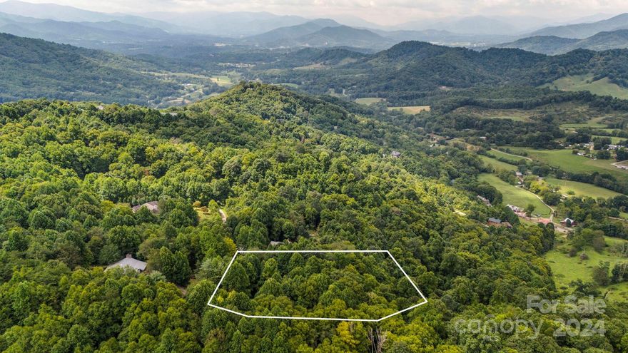 Make your dream of building in Western North Carolina a reality with this beautiful south-west facing lot in Hunter's Ridge. You'll have end of road privacy with this over 2.5 acre lot. Winter views could be made year round with selective trimming/cutting. Relatively short driveway access and ease of grading and clearing for a fall away walkout basement make this an easier build. This lot already has 3 bedroom septic approval on file with Haywood County and a new survey. Just under 3,500 feet in elevation, only 15 minutes to downtown Canton, 30 minutes to downtown Asheville and 10 minutes to I-40.