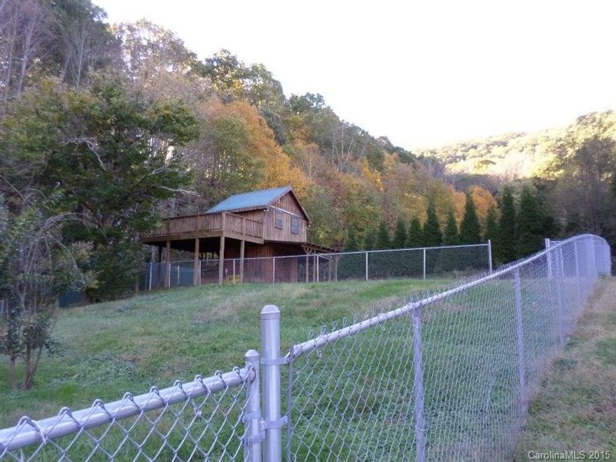 Small cabin on property with heat/AC, full bath, kitchen sink (not indicated on tax record so may have been built without a permit). Fenced. Gentle Sloping, cleared lot, ready for you custom home. Paved access on Mauney Cove Rd, to 200-300 ft of gravel. Easy drive access. Electricity and shared well already installed. Possible septic in place.  Short, dead-end street with no traffic - only 6 other home-sites. Additional 6 parcels available.