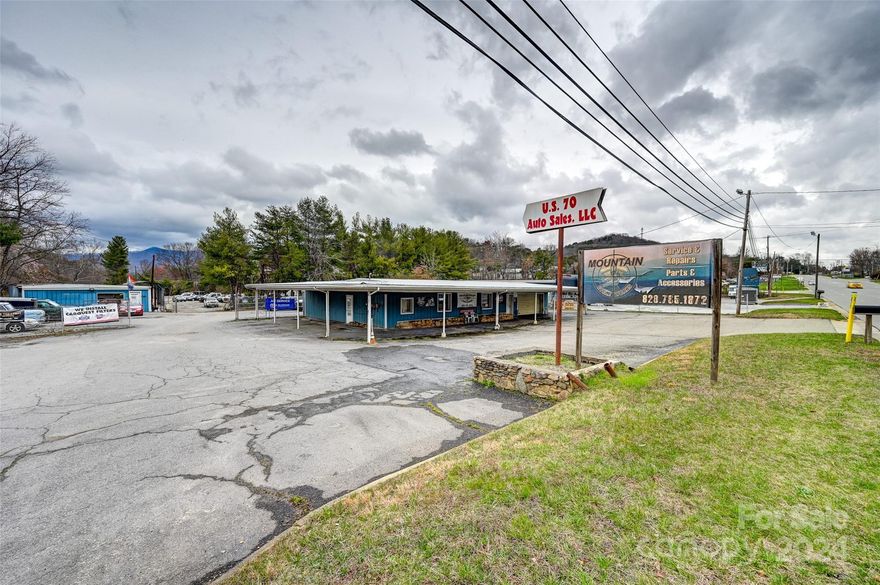 Located on high traffic count Highway 70 in Swannanoa, it is near ArtSpace. The lot has 200 +/- flat road frontage and is near the corner of New Salem road.  Currently occupied by "Mountain Cycle Works" a motorcycle repair business. The lot has a possible additional building site. Buyer to verify. Current tenant would remain dependent on the lease. There is an easement to the business behind the building. Please set an appointment to view the property and don't bother the tenant. Natural gas is in the area but not installed at the building.