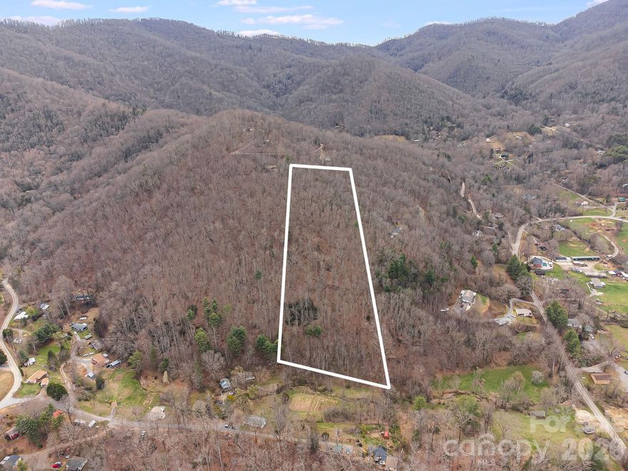 Swannanoa acreage with potential winter views, plus the opportunity for year-round views with clearing. The lower portion features a creek and small pasture area, offering a mix of natural features and usable land. Located less than 10 miles from downtown Asheville, this property offers privacy with convenient access to town. Portions of the property adjoin the Buckeye Cove community, while the homesite area provides a more tucked-away setting. Driveway, well, and septic to be installed. No known HOA or restrictions. Buyer to verify all aspects of the property including access, build-ability, and utilities. Survey on file (approx. 20 years old) appears to show easement areas along portions of the property. Buyer to verify all boundaries, easements, and current conditions.

PLEASE DO NOT DRIVE ONTO THE PRIVATE DRIVEWAY AT 70 SEAN DRIVE. Kindly respect that neighboring homeowner’s property and privacy.