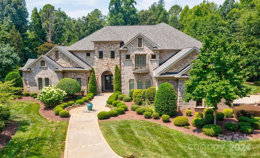 Nestled on a private, nearly 5-acre lot, this stunning custom estate is only minutes from Lake Wylie and Morningstar Marina. The breathtaking living/dining room sits just off the grand entryway, with custom beams and fixtures highlighting the vaulted ceilings. The chef's kitchen features heated tile floors, a built-in Miele espresso system, a Wolf gas range, custom cabinets, double islands & a huge walk-in pantry. The family room displays more custom exposed beams, and the built-ins & bar are a fabulous entertainment space, with a kegerator, wine refrigerator, icemaker & gorgeous stained glass. The media room is a delight for all ages. The primary suite features a multi-tiered ceiling, heated floors in the bathroom, a steam shower & a jacuzzi tub. Fabulous outdoor living! Wood-burning gas start fireplace, pizza oven, built-in gas grill& built-in fryer in the outdoor kitchen & bar. Pool & hot tub and an invisible fence. Upstairs features a gym with a sauna and two additional bedrooms.
