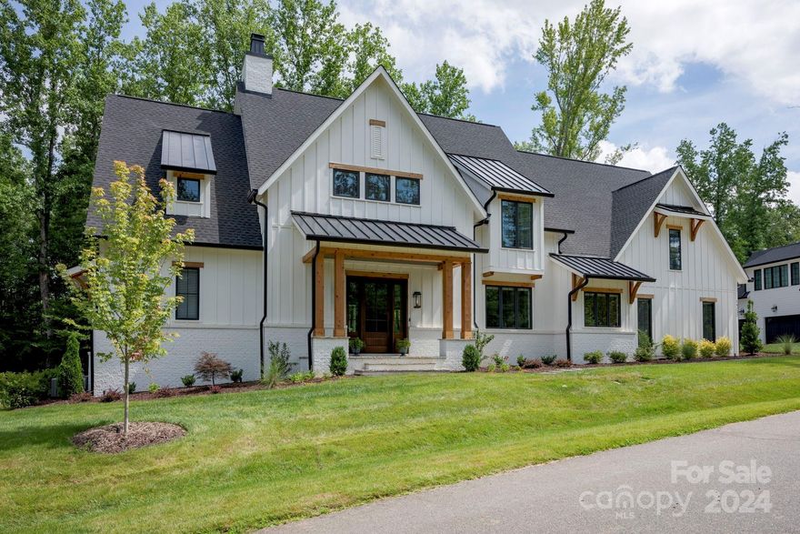 Discover architectural splendor nestled in Narrow Passage. This exceptional home, completed in 2023, harmonizes tranquility with the perfect setting for entertaining loved ones. A luxurious primary suite on the main level offers breathtaking wooded views, complemented by spacious secondary bedrooms upstairs, ensuring ample room for all.
The main level impresses with an open kitchen featuring high-end appliances seamlessly integrated with a living room boasting a gas fireplace and expansive sliders opening onto a covered patio. Adjacent, the dining room invites relaxed mealtime gatherings, with options for alfresco dining by the built-in firepit and spa. A striking office with vaulted ceilings adds dramatic flair, while a full pool bath offers convenient access to the backyard oasis. A two-car attached garage, steps from the kitchen and a generous walk-in pantry, enhances everyday convenience, with a third garage bay accessible via a covered walkway.