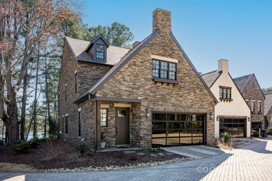 Waterfront Home in Davidson on Serene Lake Cornelius. Nestled in the peaceful community of Ambleside at Davidson, this remarkable home offers breathtaking views of Lake Cornelius. Inspired by the charm of the United Kingdom's Lake District and the picturesque town of Ambleside, U.K., this intimate neighborhood of just 14 homes reflects a timeless, English countryside style. The Grasmere plan features a main-level, lakefront primary suite, along with a spacious living room, dining area, kitchen, laundry, and drop zone, all easily accessible from the attached two-car garage. Upstairs, you'll find a generous bonus room with incredible lake views, three additional bedrooms, and an office. Relax and take in the scenic lake setting from the expansive rear porch, or walk down to the water’s edge for a convenient kayak and paddleboard launch. Enjoy the tranquility and beauty of lakeside living at its finest in the heart of Davidson.