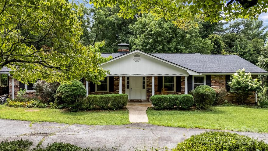 Potential, Potential, Potential! This solid brick home has tons of upside potential with over 2,000 sqft of living space on the main floor and additional 700+ space downstairs.  With a newer roof, windows, gutters, bathroom tile, downstairs carpet and flooring, and kitchen flooring, this home is waiting for you to put your special touches on the interior. Why pay for finishes that you would not pick out? Kanuga Pines is a small, quiet, well-kept neighborhood less than 3 miles from downtown. The backyard has plenty of space for a large lawn, garden, remove a few trees and open up your view of Glassy Mountain. Beautiful mature landscaping and a circular drive frame the curb appeal of this home.
     The large eat in kitchen opens onto the deck and screen porch, and carport. The den has built ins and a cozy fireplace. The downstairs has a large double garage, family room, half bath, and another room currently used a bedroom would make a great office, craft, or workout space. As Is sale.