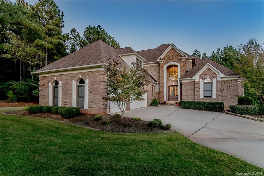 Relax in a park-like private and tranquil setting in Belmont's waterfront and gated Reflection Pointe neighborhood. Full Brick exterior construction has rock accents highlighting the quality construction. Double door arched entry welcomes guests and suggests a special attention to detail that is revealed throughout. This home exudes warmth and comfort! Owner's suite on main level has entrance to the varanda. Living area has two story windows, coffered ceiling, and rock fireplace! Welcome home!