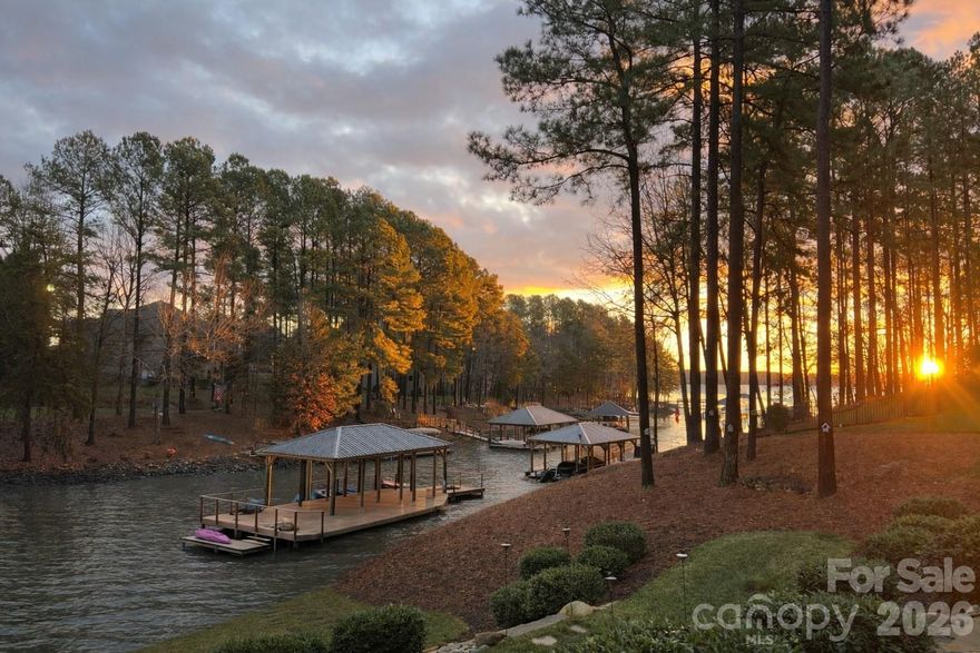 Perfectly positioned along the tranquil shores of Lake Norman, this extensively renovated waterfront residence in the prestigious Northview Harbour community embodies refined lake living at its finest. Sweeping water views, mature hardwoods, and a custom-built dock spanning nearly 1,000 square feet create a truly elevated waterfront experience. Designed with Wolf poly decking, a 10,000 lb remote lift, Wi-Fi controlled lighting, and positioned on year-round deep water, the dock is both a statement piece and a lifestyle asset.

Inside, the home is drenched in natural light, thoughtfully curated with extensive upgrades throughout. The main level offers effortless living with an inviting great room anchored by a fireplace, whole-home audio integration, and a beautifully upgraded kitchen featuring Bosch appliances, granite surfaces, and premium finishes. The primary suite is a true retreat, showcasing a spa-inspired custom bath renovation and a tailored closet system. Secondary bedrooms and beautifully remodeled baths on the main level provide both comfort and sophistication.

The walkout lower level functions as a private extension of the home with a full secondary living quarter complete with kitchen (GE appliances and Bosch refrigerator), granite countertops, living room with fireplace, surround sound, oversized flex space ideal for recreation or media, and a dedicated gym. Whether hosting extended family or creating the ultimate entertainment zone, the design delivers versatility without compromise.

This residence is as functional as it is beautiful. Enhancements include a Generac 22kVA whole-home generator, tankless hot water system, Level II hardwired EV charger, epoxy flake garage flooring with custom cabinetry and slat wall storage, aluminum under-decking system, upper and lower patio speakers, irrigation pulled directly from the lake with Wi-Fi Rainbird control, Google Nest thermostats and cameras, pre-wired security, invisible pet fencing, and integrated whole-home speaker systems throughout key living spaces.

Outdoors, expansive patios and covered spaces invite year-round enjoyment of the lake. The combination of deep water, high-end mechanical systems, premium finishes, and extensive renovations make this a rare opportunity to secure a turnkey waterfront property in one of Lake Norman’s most desirable communities.

This is not simply a lake house — it is a fully realized Lake Norman lifestyle.