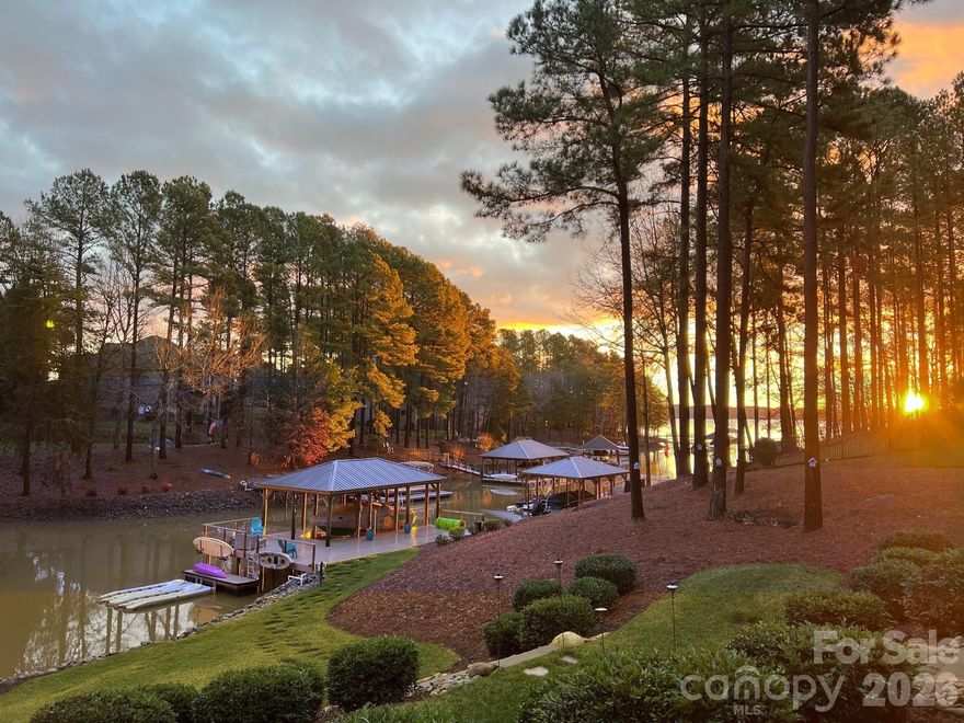 Perfectly positioned along the tranquil shores of Lake Norman, this thoughtfully designed waterfront residence in the prestigious Northview Harbour community embodies refined lake living at its finest. Sweeping water views, mature hardwoods, and a custom-built dock spanning nearly 1,000 square feet create a truly elevated waterfront experience. Designed with Wolf poly decking, a 10,000 lb remote lift, Wi-Fi controlled lighting, and positioned on year-round deep water, the dock is both a statement piece and a lifestyle asset.

Inside, the home is drenched in natural light, meticulously maintained with extensive upgrades throughout. The main level offers effortless living with an inviting great room anchored by a fireplace, whole-home audio integration, and a beautifully upgraded kitchen featuring Bosch appliances, granite surfaces, and premium finishes. The primary suite is a true retreat, showcasing a spa-inspired custom bath and a tailored closet system. Secondary bedrooms and beautifully updated bathrooms on the main level provide both comfort and sophistication.

The walkout lower level functions as a private extension of the home with a full secondary living quarter complete with kitchen (GE appliances and Bosch refrigerator), granite countertops, living room with fireplace, surround sound, oversized flex space ideal for recreation or media, and a dedicated gym. Whether hosting extended family or creating the ultimate entertainment zone, the design delivers versatility without compromise.

This residence is as functional as it is serene. Enhancements include a Generac 22kVA whole-home generator, tankless hot water system, Level II hardwired EV charger, epoxy flake garage flooring with custom cabinetry and slat wall storage, aluminum under-decking system, upper and lower patio speakers, irrigation pulled directly from the lake with Wi-Fi Rainbird control, Google Nest thermostats and cameras, pre-wired security, invisible pet fencing, and integrated whole-home speaker systems throughout key living spaces.

Outdoors, expansive patios and covered spaces invite year-round enjoyment of the lake. The combination of deep water, high-end mechanical systems and premium finishes make this a rare opportunity to secure a turnkey waterfront property in one of Lake Norman’s most desirable communities.

This is not simply a lake house — it is a fully realized Lake Norman lifestyle.