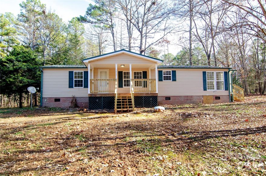 UPDATED 3-bedroom, 2-bathroom home situated on a spacious 2.4-acre wooded lot. Relax and unwind on either the front or back covered deck listening, tinker around in the 2 Bay shed and Store your RV equipment in the carport.