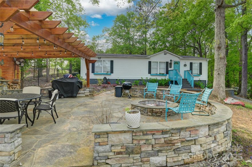 Super neat lakefront home on Lake Wateree! This is a completely remodeled home inside and wonderfully designed hardscape and exterior entertaining areas outside. Completely turn key, ready for you to relax and enjoy the tranquil views and privacy of the lake. Inside features Luxury Vinyl Plank flooring, brand new tile floors and showers in the bathrooms, Butcher block countertops, nearly new appliances, recent paint, nice trim work throughout and more. Some furnishings and decor negotiable for purchase.
Outside the gently sloping lot you will love the covered patio and outdoor cooking and entertainment area overlooking the lake. Recently built shed for all the toys and tools. Fire pit and kayak rack. New fencing on the lakeside for the children and pets. Extensive hardscaping including retaining walls, stone patio and sitting areas. And enjoy your own private pier with floating dock.