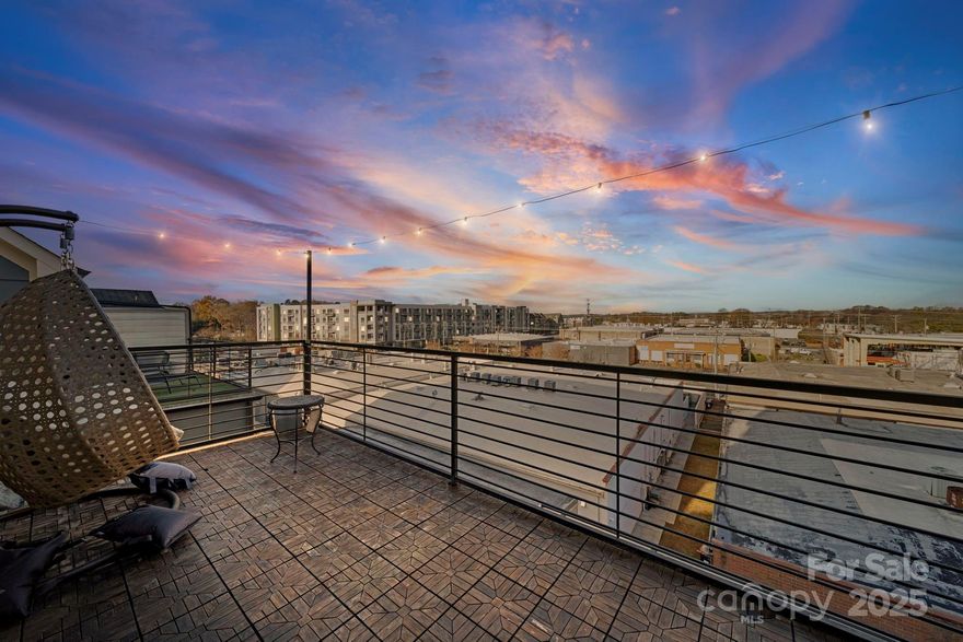 Now offered at a reduced price with a $5,000 credit toward closing costs with an acceptable offer, this end-unit townhome in gated South Village delivers modern living right in the heart of LoSo.

Built in 2019 and freshly painted throughout, this 3-bedroom, 3.5-bath home features a smart four-level layout where every level serves a purpose. Additional end-unit windows and an open main-level design create a bright, welcoming feel, with hardwood floors throughout the main living spaces. The kitchen flows seamlessly into the dining and living areas, making everyday living and entertaining easy. Upgraded wood stair treads add a clean, elevated finish throughout the home.

The fourth-floor flex space is a true differentiator. With a solid wood door that provides added separation, this level is ideal for remote work, a creative studio, fitness room, or private retreat—offering flexibility rarely found in townhome living. Step directly from this space onto the private rooftop terrace, where wide views create the perfect setting for morning coffee, evening downtime, or hosting friends.

Additional highlights include wired surround sound with zone controls for interior spaces and balconies, plus a spacious two-car tandem garage with epoxy flooring, extra storage, and direct access to a lower-level patio.

All of this is set inside a secure, gated community just steps from LoSo’s breweries, restaurants, entertainment, the Rail Trail, and light rail, with quick access to Uptown. End-unit privacy, a true flex level, and a rooftop terrace combine with low-maintenance living in one of Charlotte’s most vibrant neighborhoods.