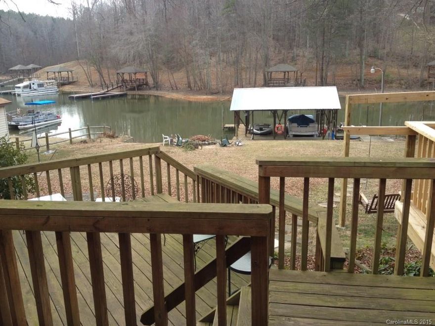Lake Norman Lakefront home with huge floating dock and two covered boatslips.  This is the hard to find affordable waterfront Lake Norman property you have been looking for.  The property features a level lot with great backyard, single detached garage or workshop, large lakeside windows to maximize the view and light, open feel, split bedroom plan, master suite with garden tub, and multiple lakeside decks to enjoy the views and the shade.