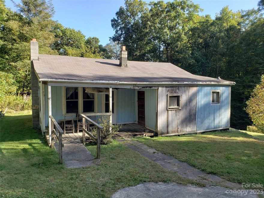 Incredible property just 2 miles from Max Patch and adjoins THE NATIONAL FOREST. You can't go wrong with this approx 8.45 acre piece of property (New Survey in attachments).  Quiet setting with amazing view from the Little Blue house. This property is on both sides of Little Creek with streams and creeks running through it.  This Little Blue house has been gutted and ready for your vision and creativity. There are 2 great build sites and possibly more on the other side of the road and property.  Solar panels in the yard were installed for a camper during renovations.  No septic on file. Buyer to verify all info. Seller makes no representation to the home since they have not lived in it and were going to remodel. French Broad fiber optic is available on Little Creek. This property is Sold as Is Where Is. PLEASE USE CAUTION WHEN WALKING IN THE BLUE HOUSE. PLEASE ADULTS ONLY. THERE ARE SOME HOLES IN THE FLOOR!