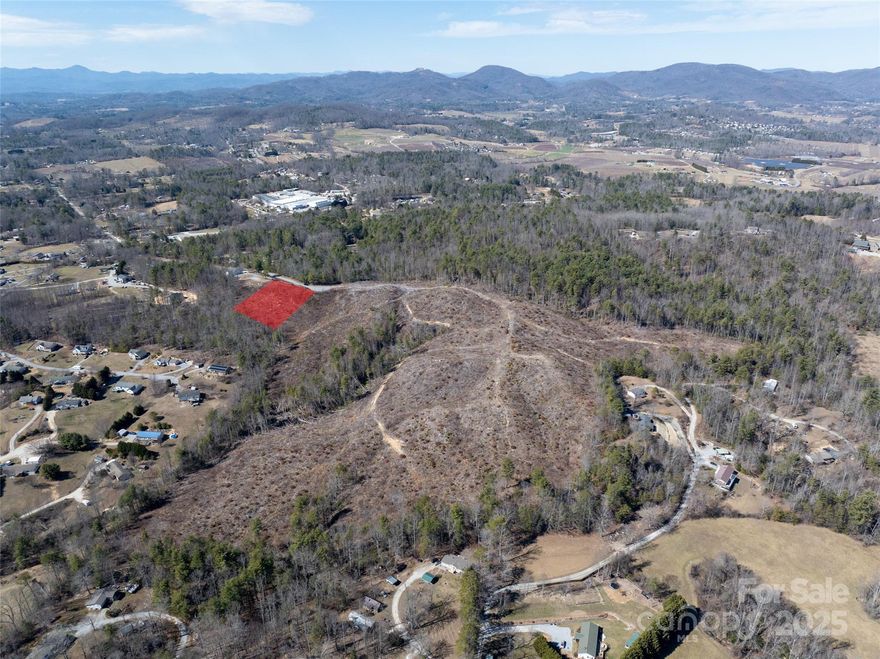This stunning 1.06-acre lot offers breathtaking long-range mountain views, providing the perfect backdrop for your dream home. The land has been thoughtfully cleared, making it easy to envision your ideal build site while still allowing for privacy and natural beauty. With a gentle slope, the property provides excellent drainage and potential for a walkout basement or multi-level design. Whether you're looking to create a private mountain retreat or a full-time residence, this lot combines serene surroundings with endless possibilities. Don't miss the chance to own a piece of paradise with panoramic views and peaceful mountain living!