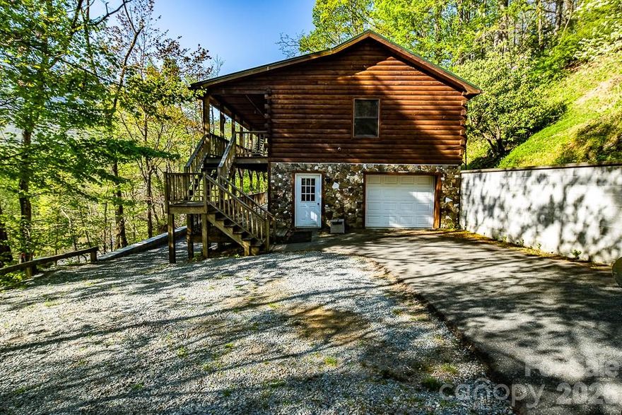 Discover the perfect mountain retreat just 3 miles from the Lodge at Sugar Mountain Resort. This charming 2-bedroom, 2-bath cabin offers seasonal Grandfather Mountain views and a layout designed for comfort and flexibility.
The main level features an open living area with abundant natural light, while the lower-level family room provides additional space for guests, recreation, or cozy evenings.  A basement garage adds convenience and good storage for outdoor gear.  Ideal as a full-time residence, vacation home, or investment property, this cabin allows both short-term and long-term rentals.  Located a short drive to ski slopes, hiking trails, golf, tennis, fishing, local attractions, grocery stores, and pharmacies, this home places the best of the High Country right at your doorstep. Whether you’re seeking adventure or relaxation, this mountain getaway offers it all.