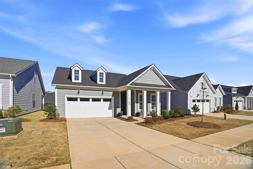 Experience elevated, lakeside living just 15 minutes from Uptown Charlotte in this stunning 1.5-story Toll Brothers home in the Griffith Lakes community. Designed with both style and functionality in mind, this home features an open floor plan with LVP flooring throughout the main living areas, neutral paint, and modern finishes. The kitchen shines with quartz countertops, tile backsplash, stainless steel appliances, a spacious island with sink and seating, and a walk-in pantry. The main-level primary suite offers a private retreat with a large walk-in closet and an updated bath featuring an expansive walk-in shower with a frameless glass door and quartz double vanities. Upstairs, a versatile loft provides flexible space for a home office, media room, or guest area. A large unfinished attic space offers excellent storage or the opportunity for a buyer to finish for additional living space. Enjoy low-maintenance living with lawn care included, along with access to resort-style amenities including a pool, fitness center, pickleball and tennis courts, dog park, walking trails, sidewalks, and more. Griffith Lakes is a master-planned, lake-centered community featuring three private lakes, a kayak launch, fishing pier, and over 150 acres of preserved green space, offering a lifestyle that truly stands out. Don't miss this one - schedule your showing today!