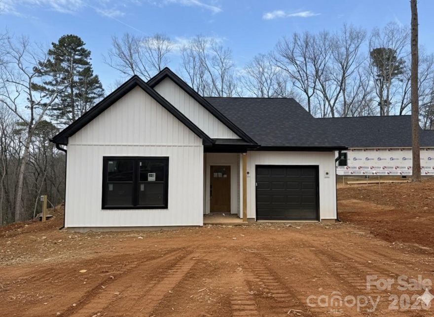 This new 1,240 sq. ft. bungalow features a clean, functional design with a modern black-and-white color palette. The open floorplan connects the main living area to a kitchen finished with custom cabinetry. Throughout the home, all closets are outfitted with wooden shelving, and the laundry area includes additional cabinet storage.

The primary suite includes an ensuite bath featuring a double vanity and a large, tiled walk-in shower with a double-hinged door, and a walk-in closet. Two additional bedrooms and a one-car garage complete the layout.

Located in the gated Carolina Forest community, this home offers access to Lake Tillery, including a community boat launch, waterfront pool, and clubhouse.