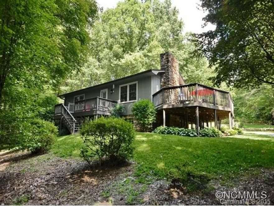 Charming home on 1.8 acres of wooded privacy. Home has had some updating including the kitchen, wrap around deck, two stone fireplaces (the one in the basement has no damper, set up for wood stove). Hardwood & laminate floors, SS appliances, large family room, eating area, hobby room & half bath on the LL w/outside access. Well & septic, but city water a& natural gas available on Mills Gap. Perfect private retreat close to everything.