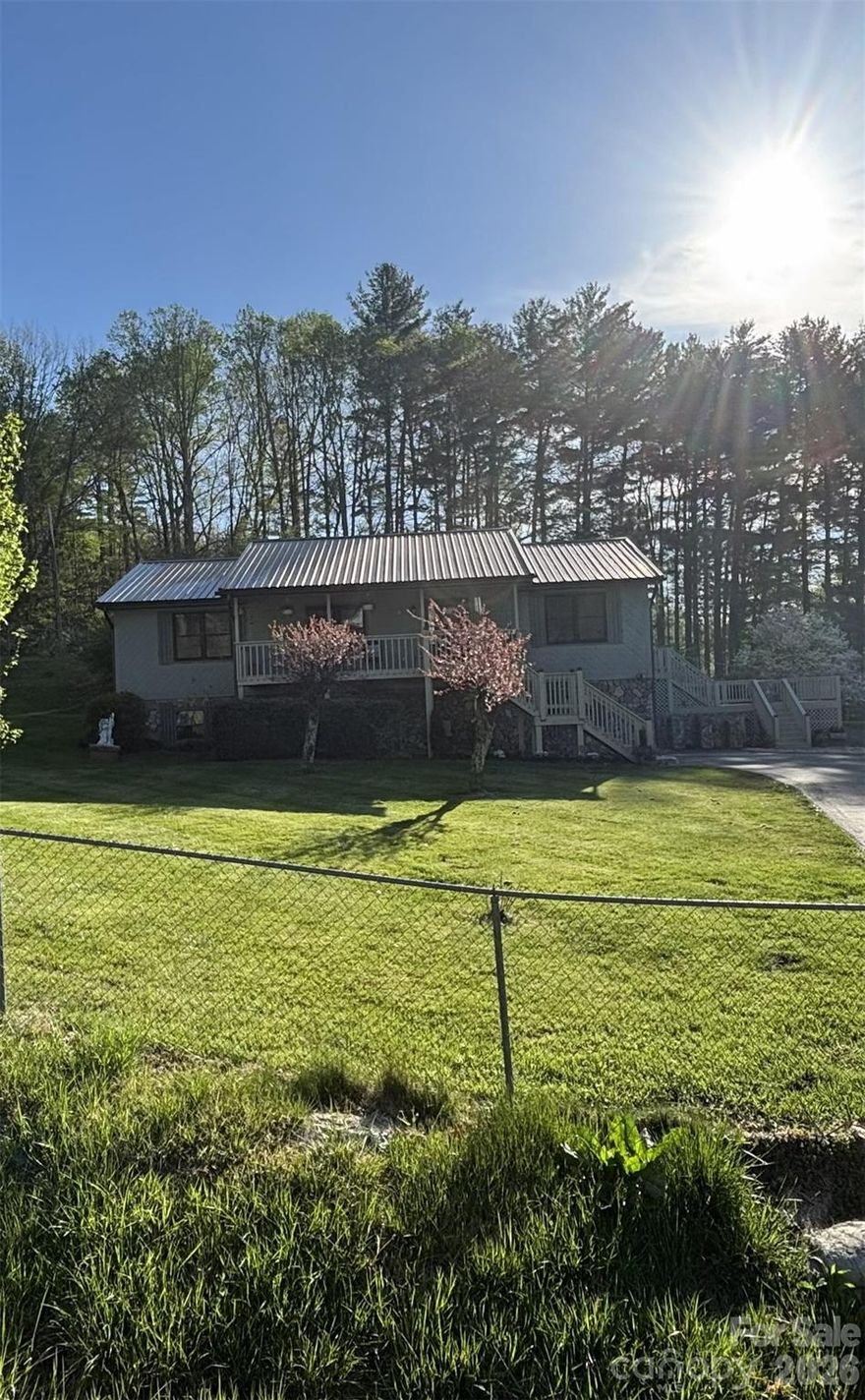 MOTIVATED SELLERS FOR COMPLETELY REMODELED HOME in highly desirable town of Burnsville, NC.  THIS PROPERTY WAS NOT AFFECTED BY HURRICANE HELENE IN ANY WAY.  Enter by Front Porch or thru Garage.  Never worry about too many stairs to climb as this meticulous home has a Full Sized Polluck Lift Elevator in the basement & opens up to the Living Room area.  Enjoy Open Concept living in this Turn-Key home.  Kitchen features Cherry wood cabinets, Granite countertops & Stainless Steel appliances.  Family Room is cozy & inviting with knotty pine walls, cathedral ceiling & electric Fireplace.  Mountain views can be seen from Front Porch & every window, including views of Mt. Mitchell from the back Deck.  UPGRADES INCLUDE:  All new windows throughout, Full Sized Elevator, Wood flooring, entire Kitchen, both Bathrooms, Interior/Exterior doors, 4 Ton Heat Pump, Washer/Dryer, Crown molding, fresh paint Interior/Exterior, window Treatments, new lighting Fixtures & Fans, automatic Garage Door, new Gutters,  remodeled Gazebo, Asphalt driveway & electric Gate, all new electrical wiring & plumbing thru-out home.
This Raised Ranch home is situated just a few minutes from Town for easy access to shopping, eclectic eats, unique boutiques, arts & crafts, horseback riding on a 20 mile trail, fly fishing & hiking to the Roaring Fork Falls.  Visit the Dark Sky Observatory for a memorable experience, along with golfing at the Mt. Mitchell Golf Club.  Enjoy small town charm & fresh mountain air at this gateway to Mt. Mitchell.  Town offers seasonal festivals to enjoy local foods, music, local Artisans & Galleries.  Book a Showing of this fantastic home today, you will NOT be disappointed.