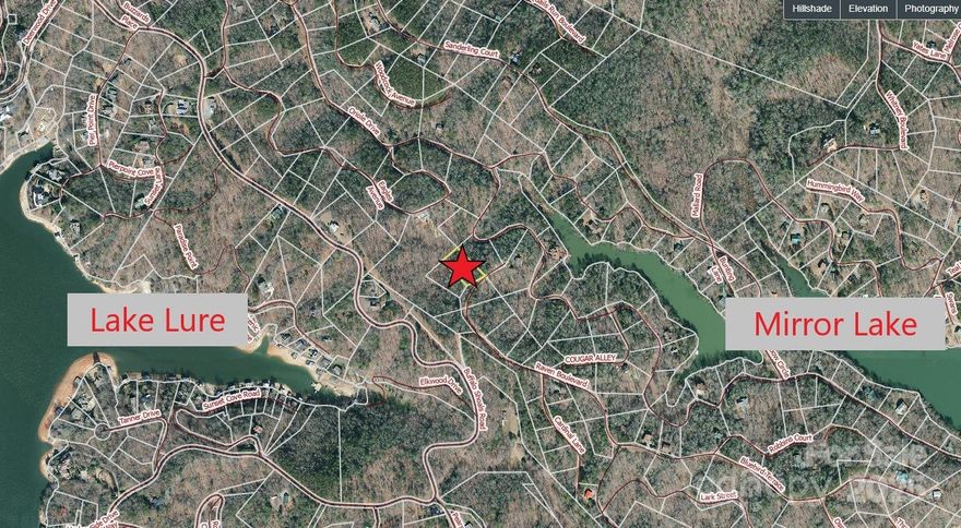 Gently sloping lot in the scenic Riverbend Community of Lake Lure, nestled between the east bank of Lake Lure and private Mirror Lake. This gated community offers a charming, summer camp feel with multiple amenities. Enjoy access to two lakes for swimming, fishing, and paddle boating, plus hiking trails, waterfalls, a swimming hole, picnic area, and a community pavilion with charcoal grills. Experience the peaceful beauty of the mountains as you explore the neighborhood. Visit riverbendlakelurepoa.com for restrictions and details. GATED COMMUNITY - scheduled showings required.