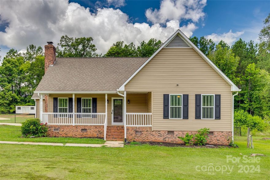 This ranch style home is a real charmer and ready for it's new owners!  Sitting on 1.6 acres, you'll appreciate the outdoor space which includes a welcoming front porch, fenced backyard, screened back deck, and an above ground pool!  Plus the side and front yards are spacious as well!  Inside, the bedrooms are all large and offer plenty of storage.  An addition to the owner's suite gives potential for a home office or sitting area.  The living room features high ceilings and a fireplace.  The footprint flows easily into a spacious dining room that opens to the back covered deck, making it easy to entertain.  The kitchen offers granite countertops and a great pantry.  And you'll love the laundry room!  The side entry makes it easy to come straight in from your driveway if you're dodging the Carolina weather or carrying in your shopping bags.  All this in a great location convenient to I-77 for an easy commute and part of the Lewisville School District.