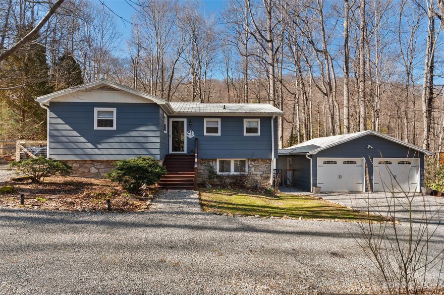 Your turnkey home in beautiful Maggie Valley awaits! Paved, year-round access makes it easy to find this upgraded 2/2 with bonus room in a well-established neighborhood. Host family and friends in the open kitchen with hickory cabinets, granite counters, and updated appliances. The generously sized primary bedroom offers ample storage and an en suite bathroom with a double vanity and a walk-in shower. The basement-level second bedroom with an attached bath is accessible from the interior and exterior. Perfect for guests or a tenant – rentals are permitted. The bonus room has variable potential as an office, gym or additional guest space. Relax on your covered porch while enjoying a fenced-in yard, firepit, and the tranquil sound of a nearby creek. Plenty of driveway parking for multiple vehicles and/or a small RV plus a 2-car detached garage with covered access. Check out the list of recent updates, there are many. Come see 322 Spring Lake, not just a house but a home.