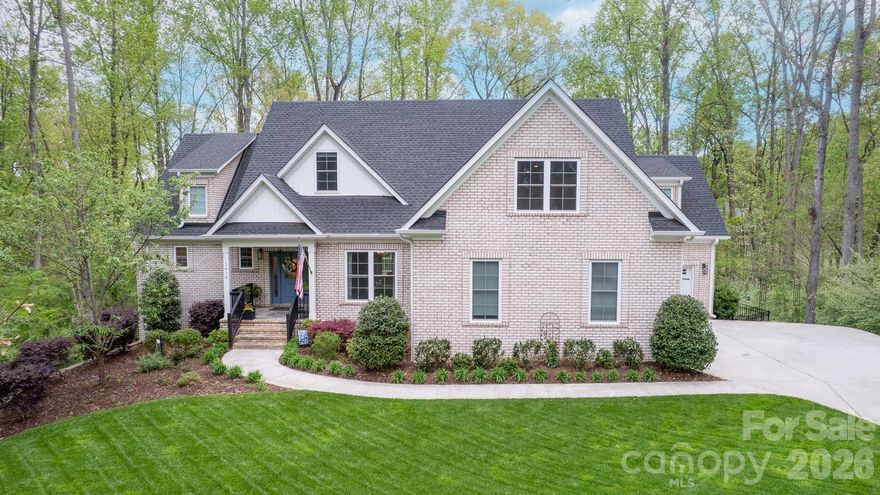 Built in 2021, this FULL BRICK home in Water Edge offers 7 bedrooms, 6.5 baths, abundant STORAGE, and a highly functional floor plan across three finished levels. The main level features a chef's kitchen with a 48-inch WOLF GAS range, SUB-ZERO refrigerator, custom cabinetry, leathered quartzite island, and a hidden walk-in pantry. A dedicated office and spacious primary suite with tree views, dual walk-in closets, and a spa-style shower complete the main level. Upstairs includes four LARGE additional bedrooms and two full baths. The walkout basement offers exceptional flexibility with TWO bedrooms, each with its own full bathroom and walk-in closet, a full second kitchen, a living area, a laundry hookup, and a home theater setup.

The backyard earns its own tour. The heated SALTWATER POOL is freeform, with travertine coping and an elevated spa finished in stacked stone. A pergola with a bar sits at the far end of the patio, with mature trees offering plenty of privacy. A full POOL BATH and expansive paver patio complete the outdoor setup. A three-car garage with new epoxy flooring ties it all together. And off the main level, a brand new Trex deck sits elevated above the backyard with views of the pool below.
Water Edge amenities include a LAKESIDE clubhouse and community pool, with convenient access to Charlotte.