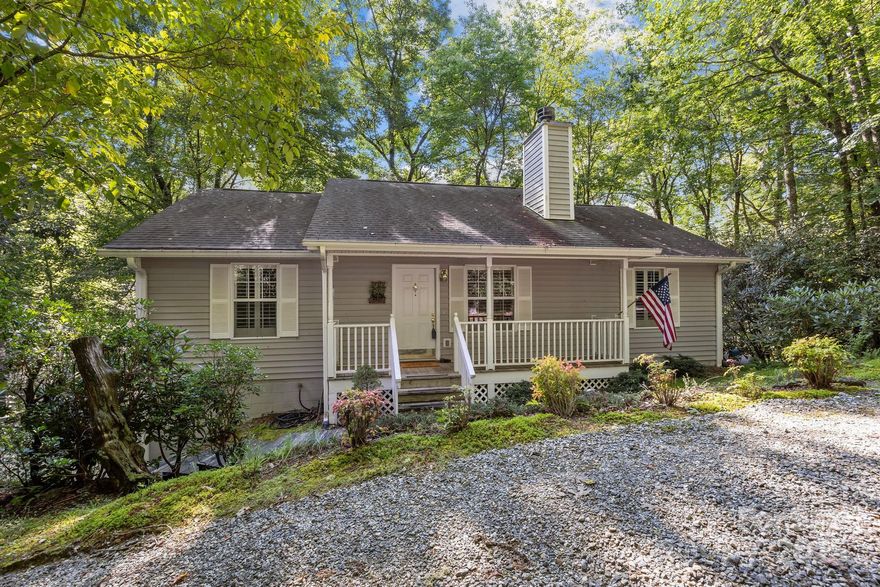 Welcome to 285 Holly Forest Court, a private mountain retreat offering all one-level living. This 3-bedroom, 2-bath home sits on a wooded .78-acre lot and features a spacious living room with hardwood floors and a cozy gas-log fireplace. The kitchen flows into the dining area and a bright sunroom with wooded views, perfect for relaxing year-round. The primary suite includes a walk-in shower and soaking tub, while two additional bedrooms provide space for family or guests. A detached two-car garage offers plenty of room for vehicles and mountain/lake toys. Just minutes to Sapphire amenities, dining, and recreation—this home blends convenience, comfort, and mountain charm.