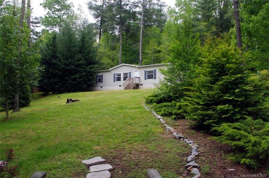 RARE FIND - Newer model double wide home on over an acre of picturesque land close to Downtown. Kitchen w/ glass front cabinets, large island, double refrigerators. Dining area w/ wood wainscotting. Opulent master suite. Split bedroom plan, all walk-in closets. Wood-look vinyl floors, new carpet. Separate mud/laundry room. Rear covered deck has privacy, peaceful wooded views. Can be purchased with 735 Price Road for multi-family living. *Owner will not sell property until 735 Price Road is sold*