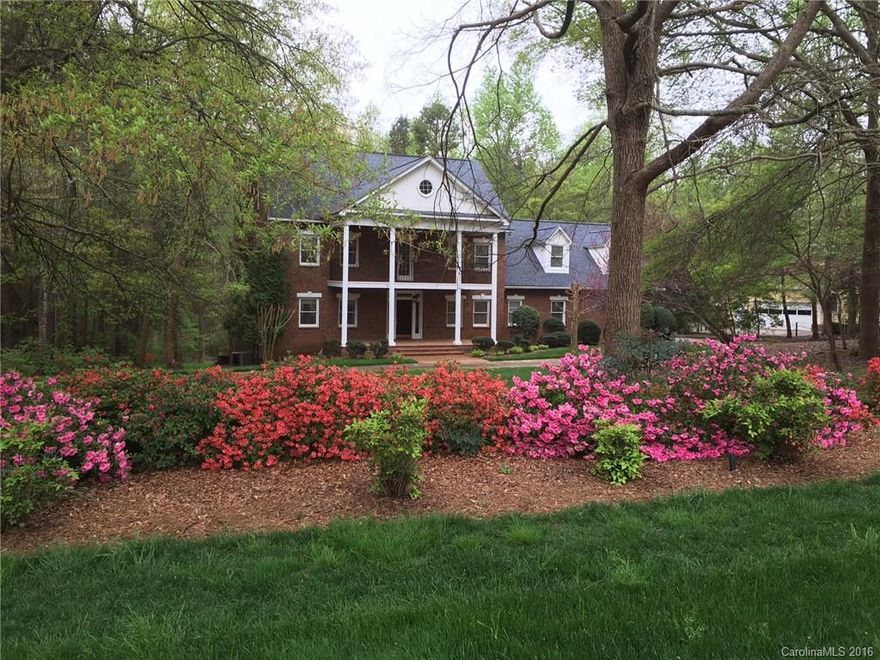 Gorgeous four-level brick home with new granite counter tops, gorgeous hardwood floors, formal living & dining, entertaining area on main level, rec room & play area on third level, water filter system, in-law suite w/ full kitchen, bath, den, fireplace and separate access. Master suite has whirlpool tub, walk-in closet and sitting area with separate entrance. Double porches on front and deck in the back. Over an acre of lush landscaping. No HOA, Ft Mill Schools.