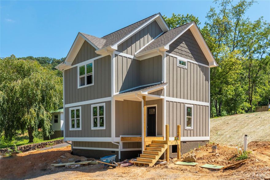 New Construction which will have quality finishes!  This home is being construction and has the foundation and framing complete.  Please drive down the street and see 12 and 14 Apple Lane for examples of what the exterior will look like - this will be the same floor plan.  This unique area is just minutes to downtown Asheville and UNCA and is being flooded with new construction.   All the photos are of a recent build with the same floor plan and options.  Construction completion time will be June 2023. Plan offers a bright and open floor plan with hardwood floors on the main level and 9' ceilings.  Gourmet kitchen open to the dining area featuring attractive center island with room for bar seating, granite counters and stainless appliances.  Upstairs is home to 2 large master suites.  Covered front porch.